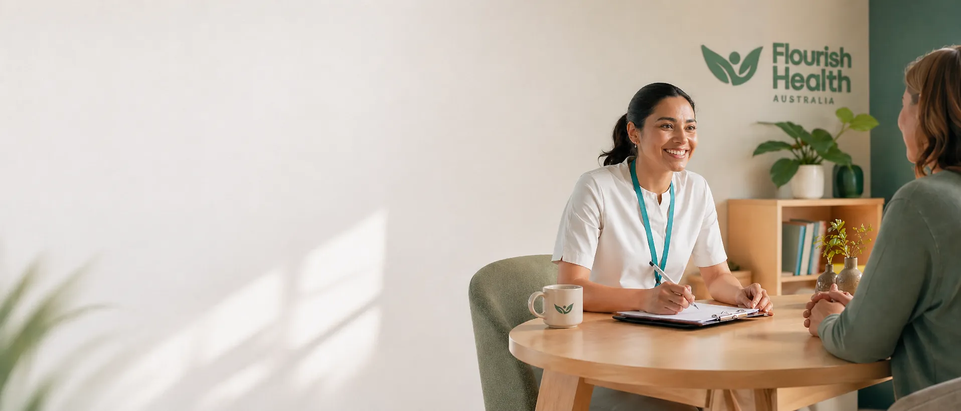 Flourish Health therapist taking notes with a client at a home visit