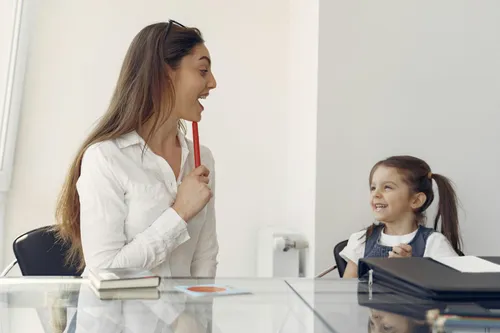 Speech pathologist working with a young child during a therapy session